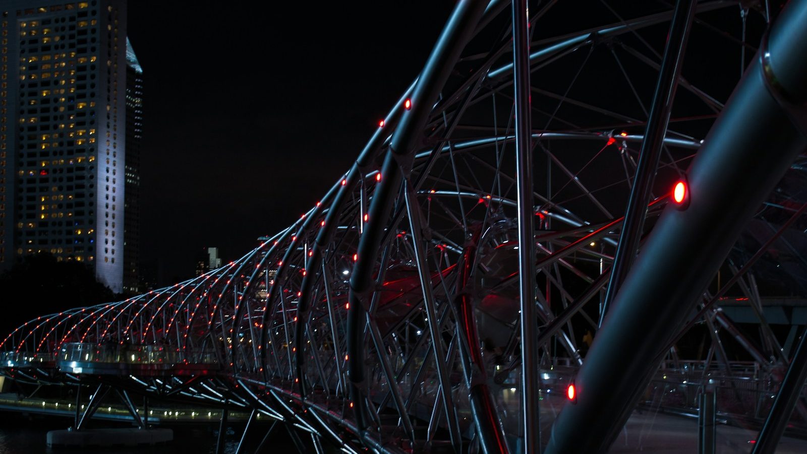 Puente Helix gris con luces rojas por la noche